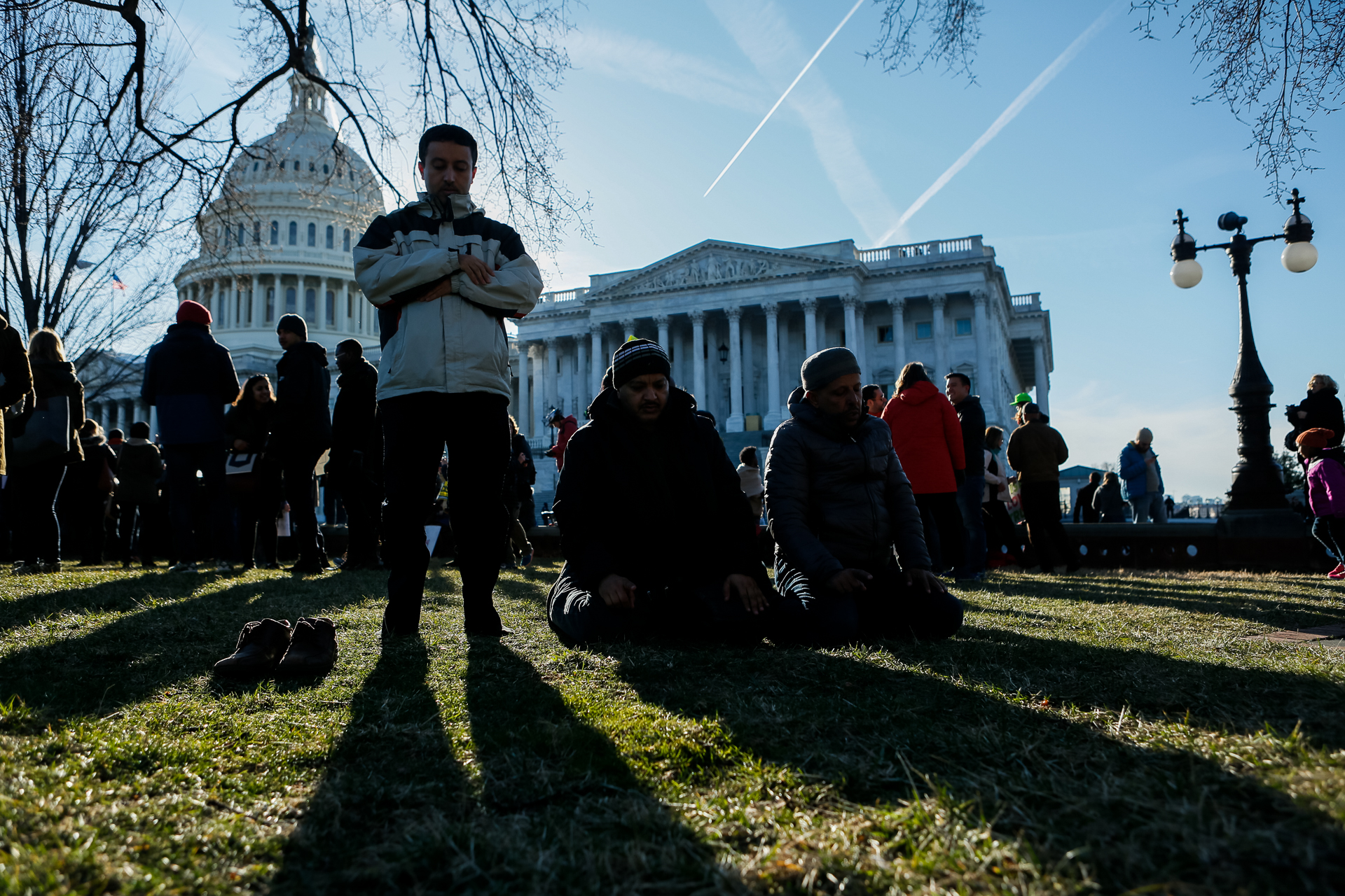 Men pray on the grounds of the Capitol during a protest of a Trump-administration immigration ban, in Washington, D.C., Feb. 4, 2017. The ban, which blocked immigrants from seven Muslim-majority countries and suspended the U.S. refugee program, was lifted the same day by a federal court and the administration vowed to appeal the ruling. (© 2017 Eric Dietrich Photography)