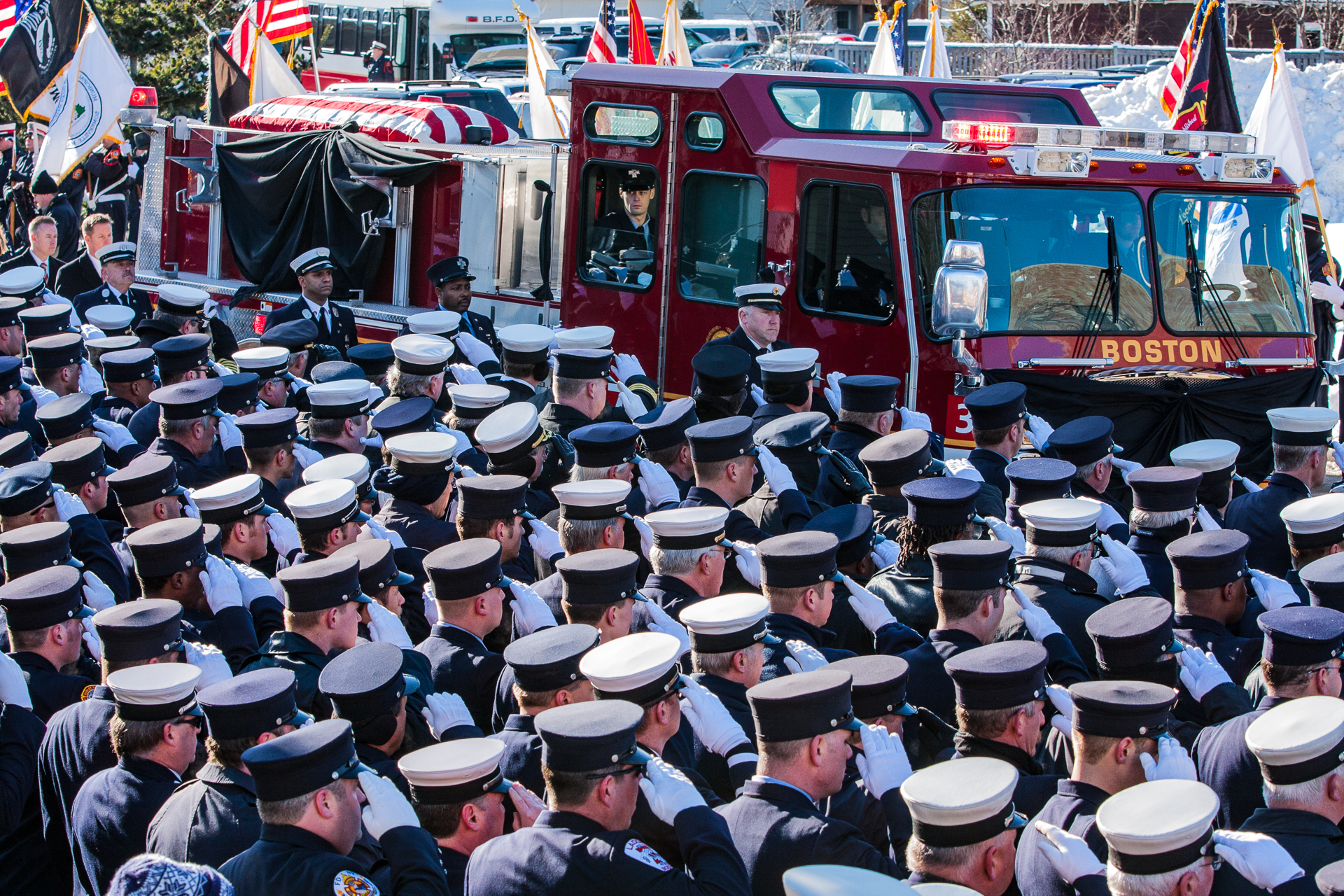 Firefighters salute the funeral procession for Boston firefighter Lt. Kevin Kelley in Quincy, Mass., Jan. 14, 2009. Kelley was killed when the brakes on his ladder truck failed and struck a building. (© 2009 Eric Dietrich Photography)