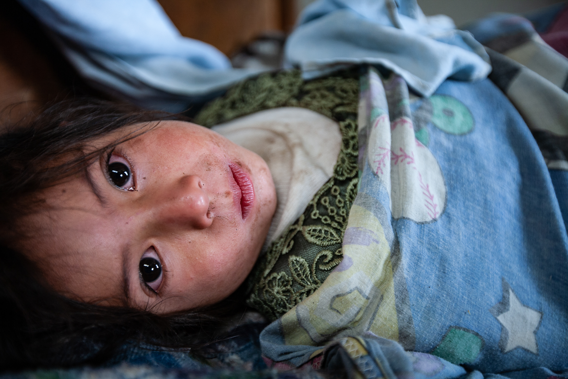 Rosita Oron-Perez, 3, lies in bed, sick with a cold, Santa Maria de Jesus, Guatemala, March 31, 2009. (© 2009 Eric Dietrich Photography)
