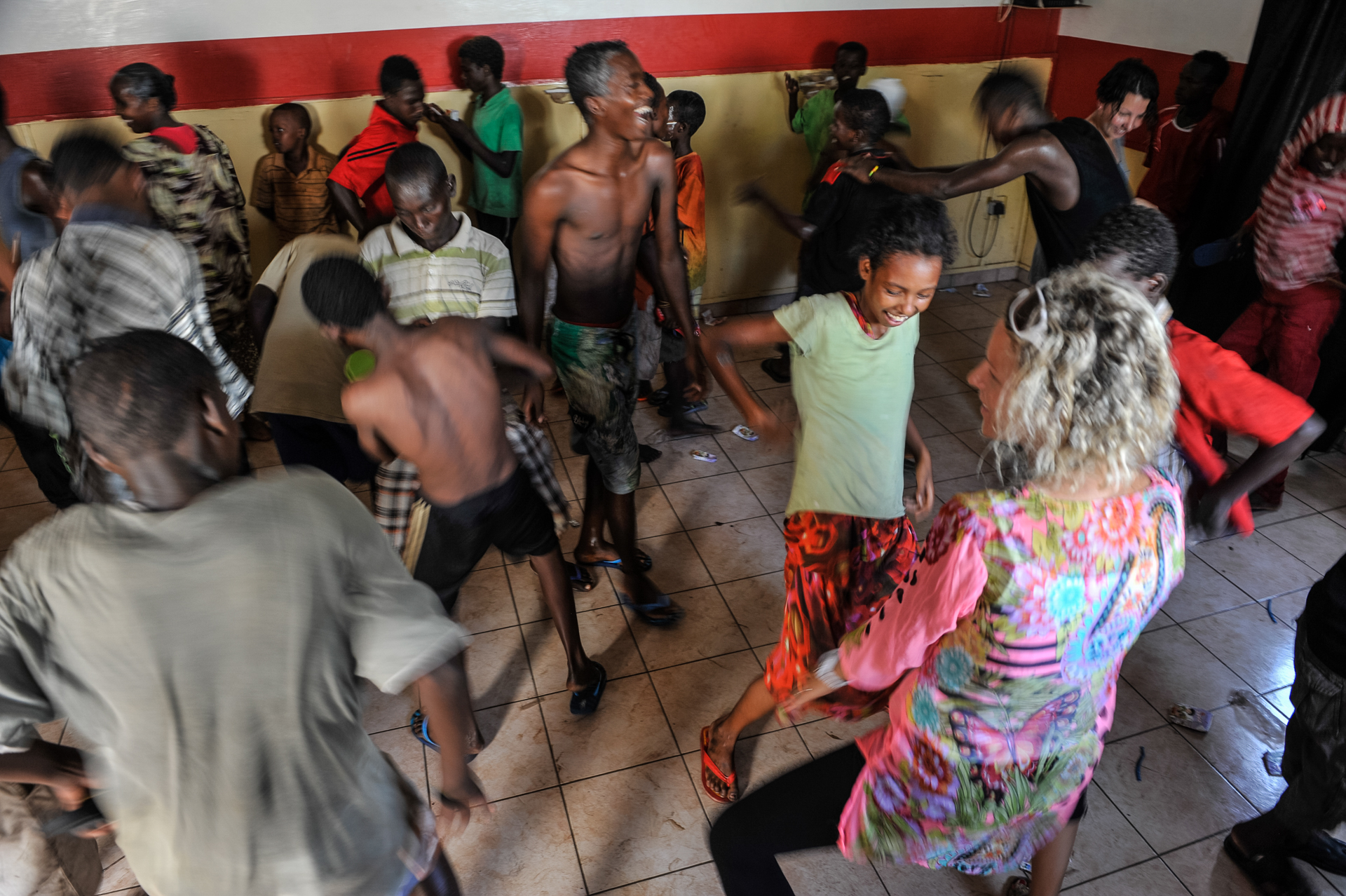 Children dance at Caritas day shelter in Djibouti City, April 12, 2014. U.S. service members from Camp Lemonnier, Djibouti, volunteer at Caritas, which provides support to women and street children. (Eric Dietrich/U.S. Navy)