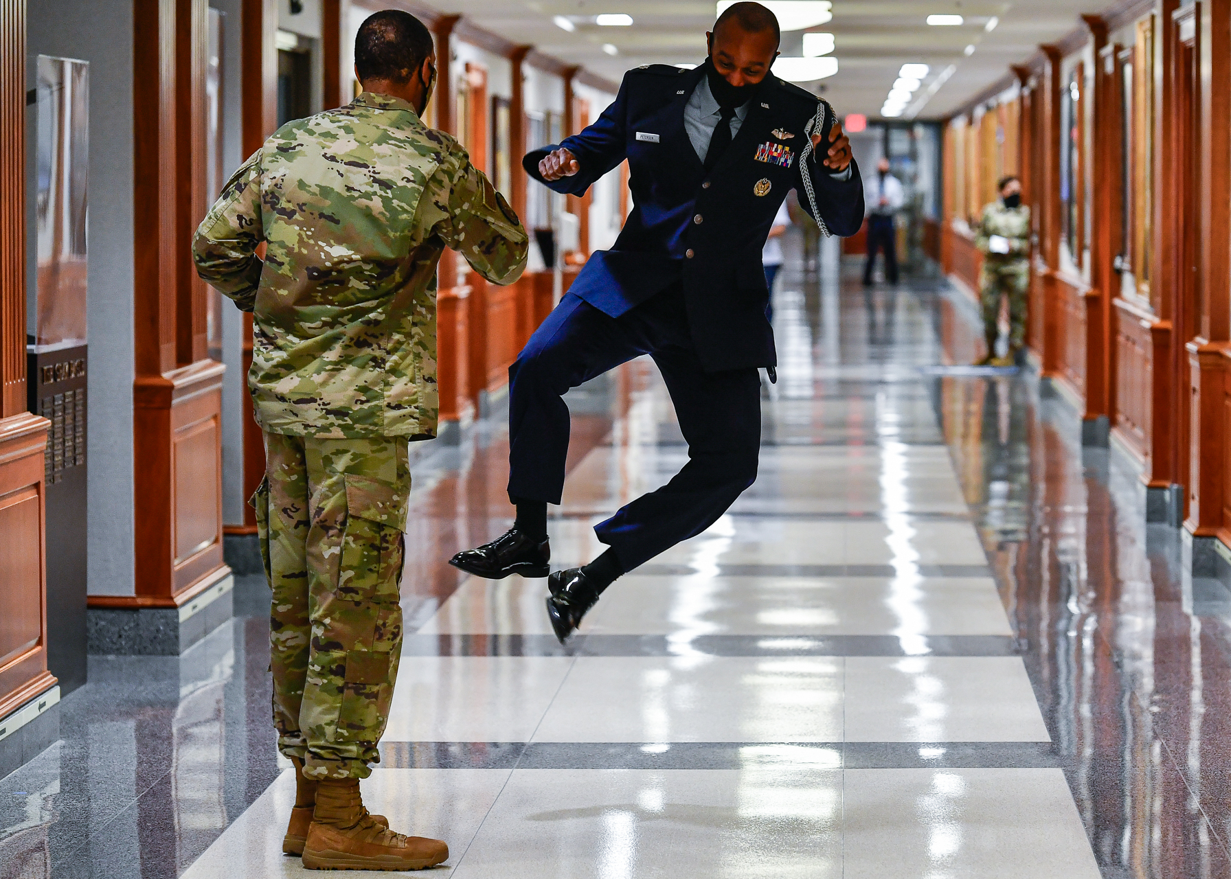 Lt. Col. Calvin Peterson, aide-de-camp to Air Force Chief of Staff Gen. David Goldfein, leaps into the air before a clap out ceremony for Goldfein as he leaves the Pentagon on his final day as the chief of staff, Arlington, Va., Aug. 5, 2020. Gen. CQ Brown, Jr. succeeded Goldfein as the 22nd Air Force chief of staff. (Eric Dietrich/U.S. Air Force)