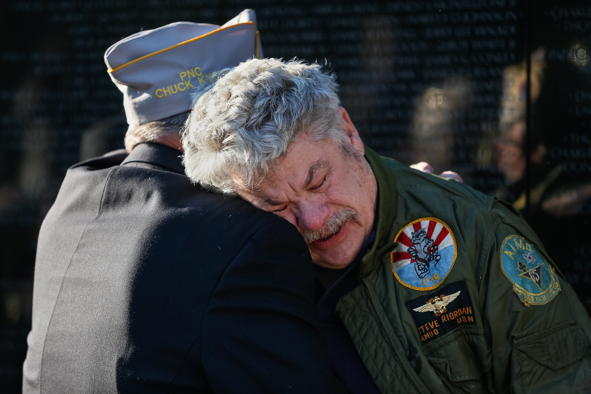 Steve Riordan embraces a fellow Vietnam veteran after a Veterans Day ceremony at the Vietnam Veterans Memorial in Washington, D.C., Nov. 11, 2018. Riordan’s friend Bill McDonald was killed when he was shot down May 3, 1972 over Hanoi, Vietnam. (© 2018 Eric Dietrich Photography)
